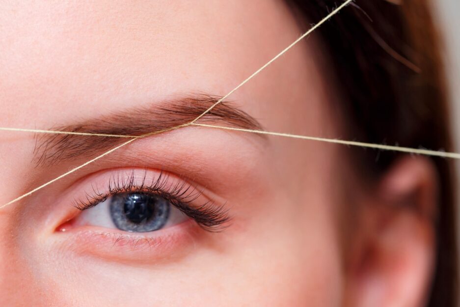 threading woman's eyebrows