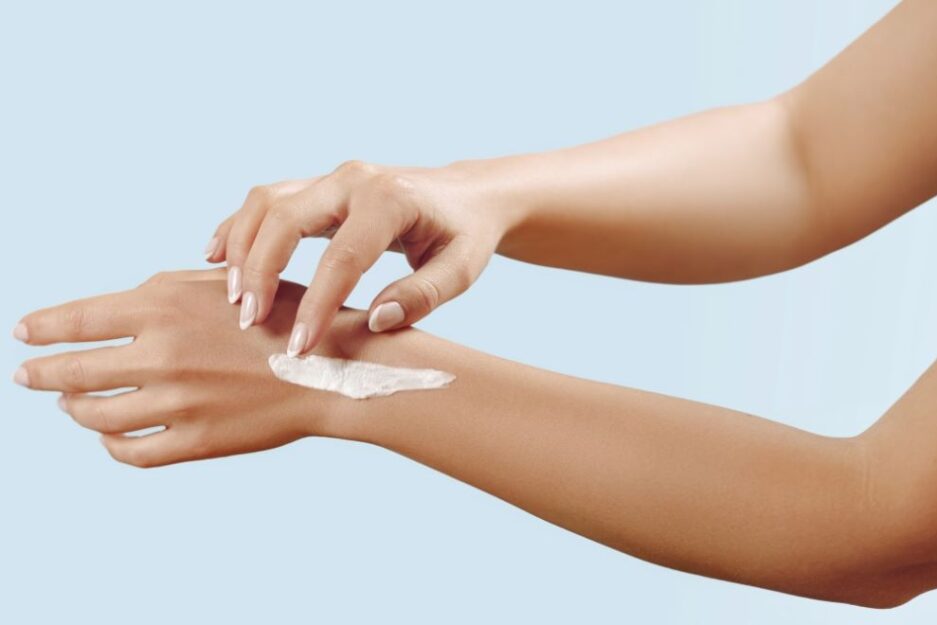 woman applying cream to skin