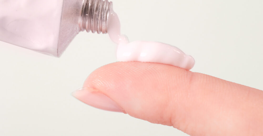 tretinoin cream being squeezed on to finger