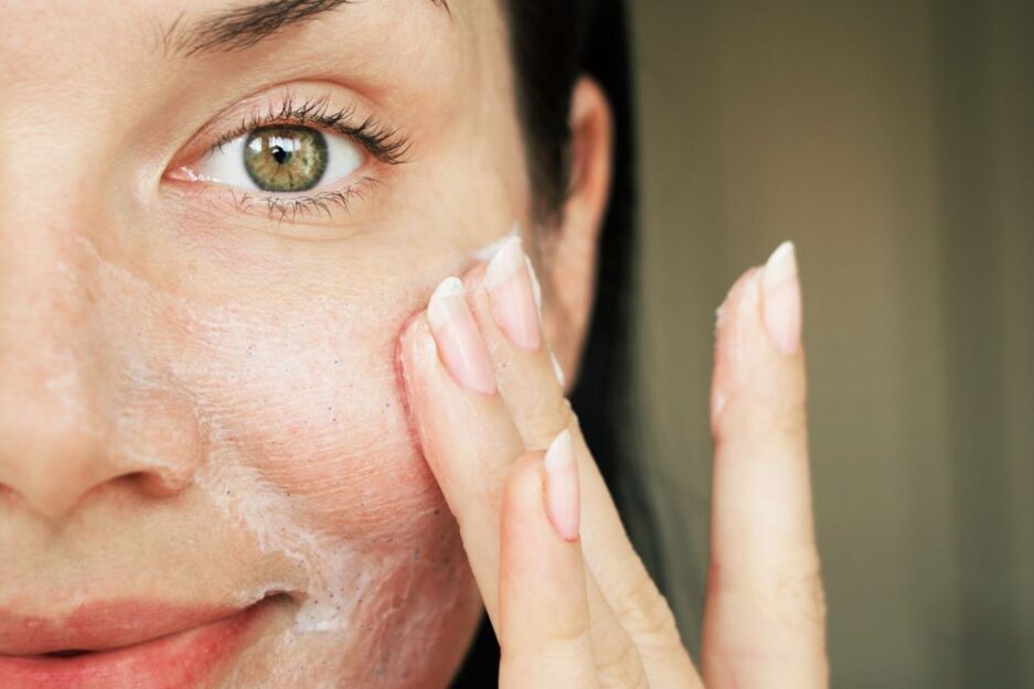 woman applying skincare to facer